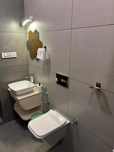 a bathroom with a toilet and a sink at Green Leaves The Countryside Inn in Ooty