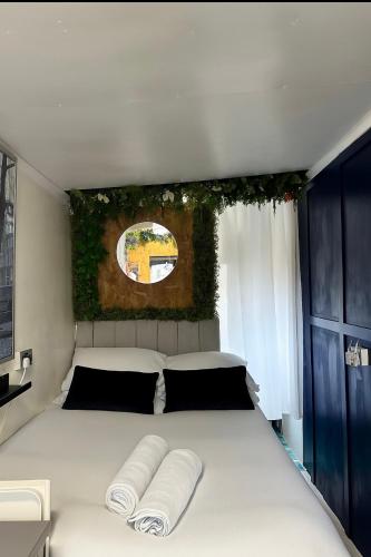 a bedroom with a large white bed with two pillows at The llyffant Shed in Cardiff