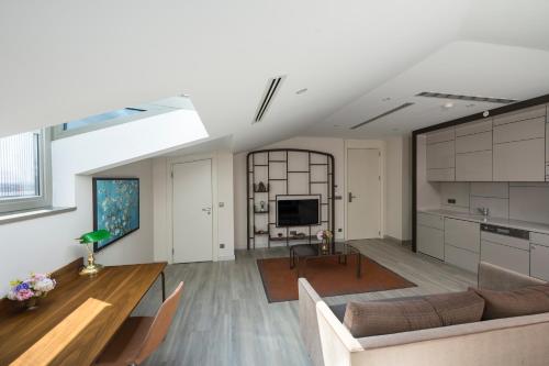 a living room with a couch and a table at Upsuites Hotel in Istanbul