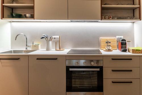 a kitchen with a sink and a stove at Borgo delle Botteghe Luxury Suites in Parma