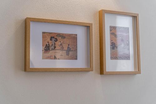 two framed pictures hanging on a wall at Borgo delle Botteghe Luxury Suites in Parma