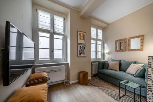 a living room with a couch and a tv at Borgo delle Botteghe Luxury Suites in Parma