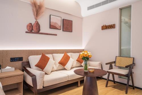 a living room with a couch and a table at L'Hôtel in Kunming