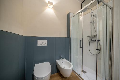 a bathroom with a toilet and a sink and a shower at Borgo delle Botteghe Luxury Suites in Parma