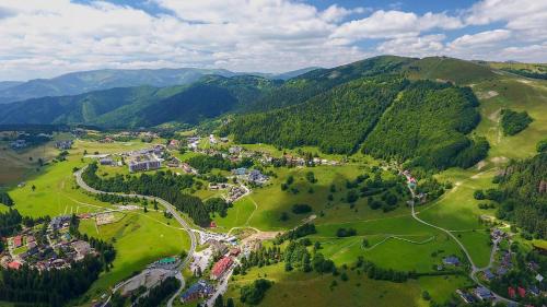 an aerial view of a town in the mountains at Kamzík Donovaly in Donovaly