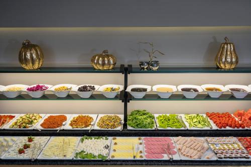 a display case filled with lots of different types of food at Upsuites Hotel in Istanbul