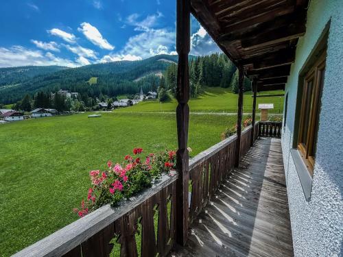 a balcony of a house with flowers on it at Nockalm Cottage in Bad Kleinkirchheim