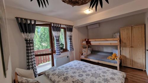 a bedroom with a bunk bed and a window at Kamzík Donovaly in Donovaly