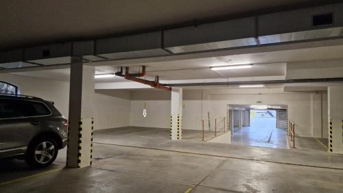 an empty parking garage with a car parked in it at Kamzík Donovaly in Donovaly