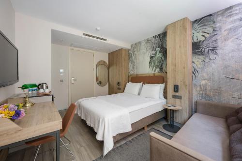 a hotel room with a bed and a couch at Upsuites Hotel in Istanbul
