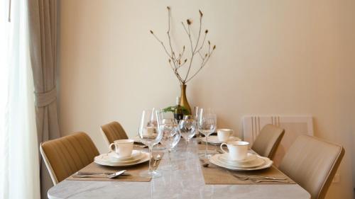 a dining table with chairs and a vase on it at Relax Nai Yang beach pool Villas in Nai Yang Beach