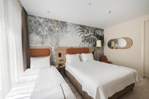 a bedroom with two beds and a mural at Upsuites Hotel in Istanbul