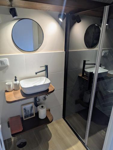 a bathroom with a sink and a shower at A Casiña Laranxa in Cangas de Morrazo