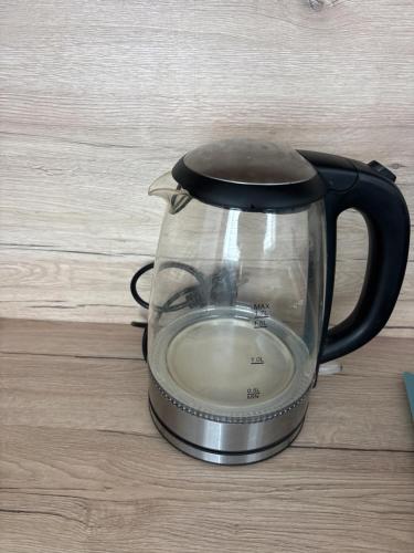 a tea kettle sitting on top of a table at Apartman Orlí hnízdo in Liberec