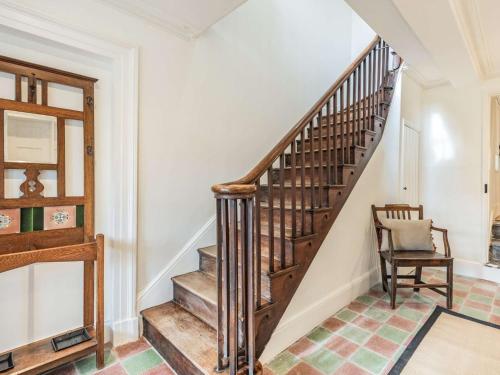 a wooden staircase in a home with a chair at 3 bed in Corwen 86266 in Corwen