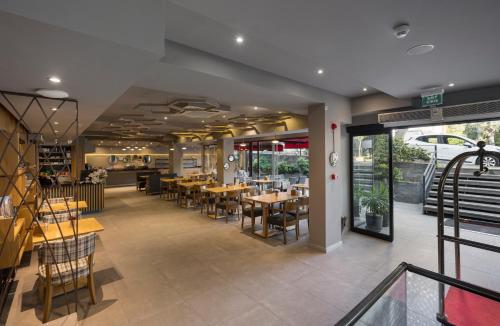 a dining room with tables and chairs in a restaurant at Upsuites Hotel in Istanbul