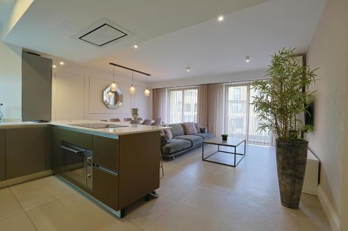 a large kitchen and living room with a couch at STYLISH 3 BED Partial SEAVIEW in St. Julianʼs