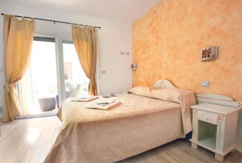 a bedroom with two beds and a window at Domo La Vela - Affittacamere - Living Sant'Antioco in SantʼAntìoco