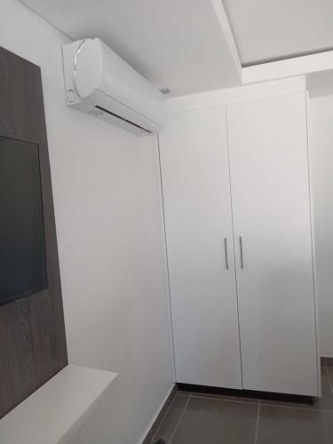 a white cabinet in a room with a tv at Lefa Guesthouse in Ledig