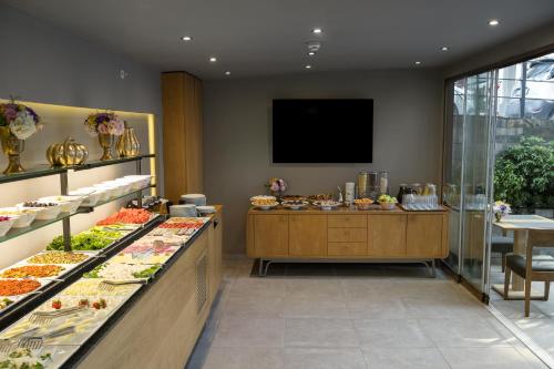 a restaurant with a buffet of food on display at Upsuites Hotel in Istanbul