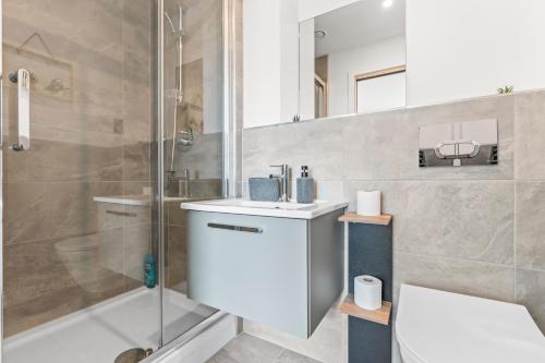 a bathroom with a sink and a shower at York Penthouse with Hot Tub & View of Minister in York