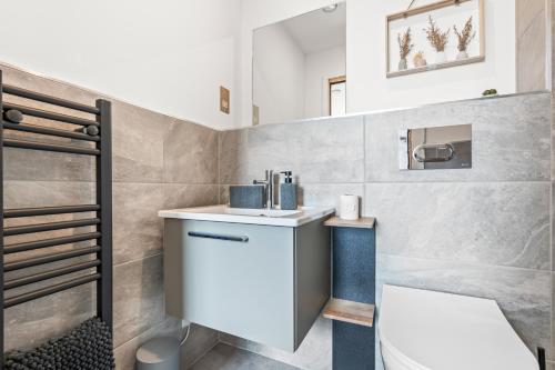 a bathroom with a sink and a toilet at York Penthouse with Hot Tub & View of Minister in York