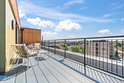 a balcony with a chair and a view of a city at York Penthouse with Hot Tub & View of Minister in York