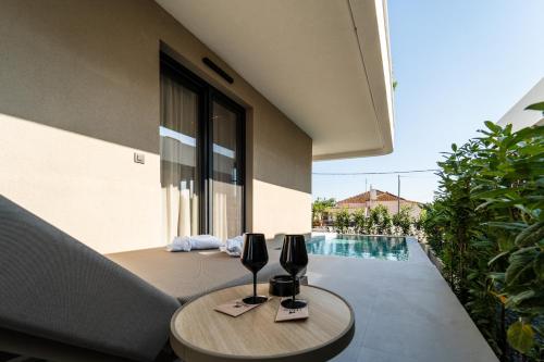 a patio with a table and chairs and a pool at Haven Luxury Living in Chaïdeftón