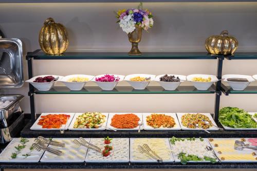 a buffet filled with lots of different types of food at Upsuites Hotel in Istanbul