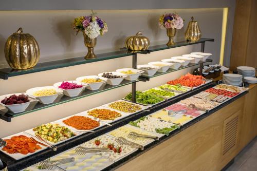 a buffet with many different types of food on display at Upsuites Hotel in Istanbul