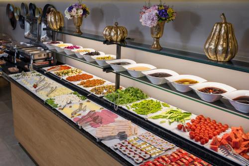 a buffet line with many different types of food at Upsuites Hotel in Istanbul