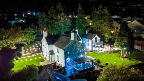 an aerial view of a house at night at Mochdre Holiday Cottages in Mochdre