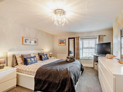 Un dormitorio con una cama y un televisor de pantalla plana. en 2 Bed in Seahouses CN082, en Seahouses