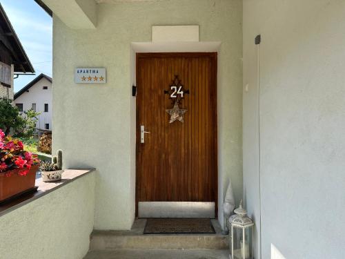 a wooden door with the number on it at Apartma Rekar - a house, where you can relax in the embrace of nature in Jesenice