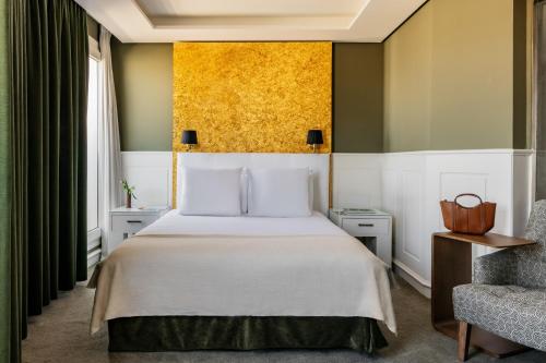 a hotel room with a bed and a chair at Hotel Colón Gran Meliá - The Leading Hotels of the World in Seville