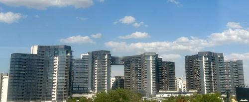 a group of tall buildings in a city at شقة فندقية بالشيخ زايد Zed residense in Cairo