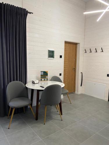 a room with a table and chairs and a door at Bilychi - садиба у Карпатах in Bilichi
