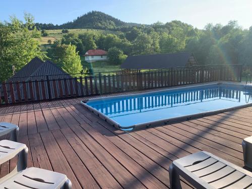 a swimming pool on the deck of a house at Bilychi - садиба у Карпатах in Bilichi