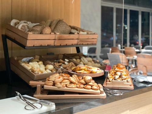 a buffet with different types of breads and pastries at Four Points by Sheraton Istanbul Kagithane in Istanbul