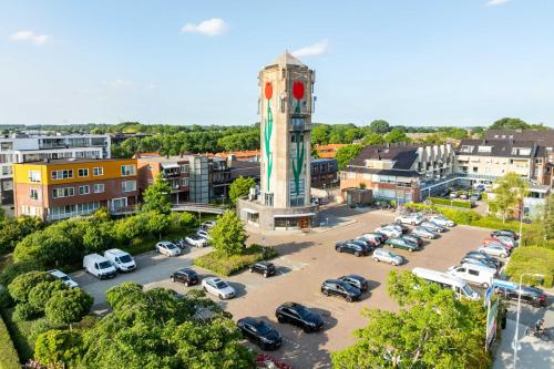 an aerial view of a parking lot with a clock tower at B&B De Tulpentoren in Roelofarendsveen