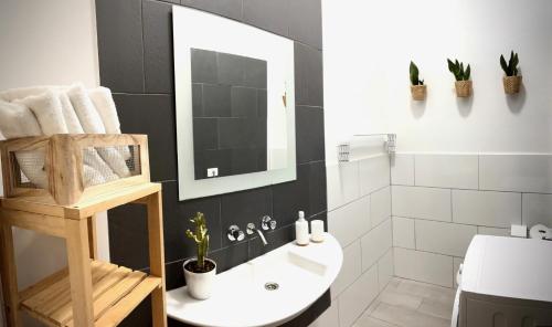 a bathroom with a sink and a toilet and a mirror at Plaza de la fuente Granadilla de Abona Tenerife sur Only Adults con terraza privada in Granadilla de Abona