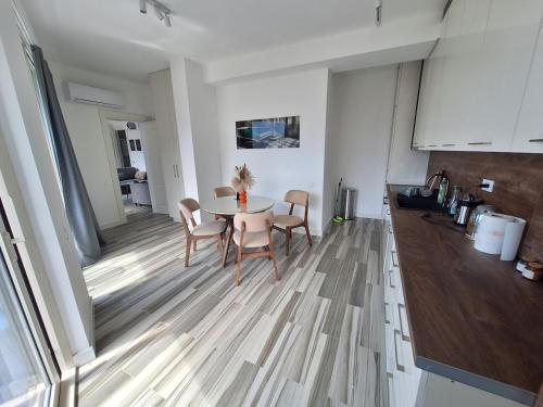 a kitchen and dining room with a table and chairs at Skyline sea view apartment in Becici