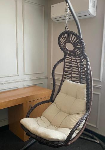 a wicker chair sitting in front of a desk at Samsun Osmanlı Otel in Samsun