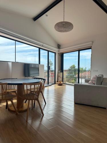 a living room with a table and chairs and a couch at Casa da Sé by PURUS in Coimbra