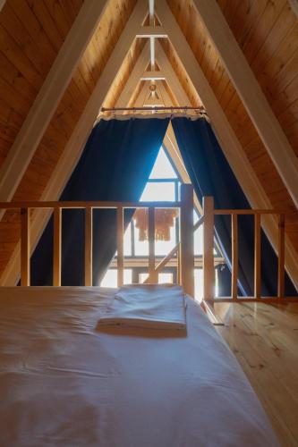 a large bed in the attic of a house at Atakum Bungalov Evleri in Atakum