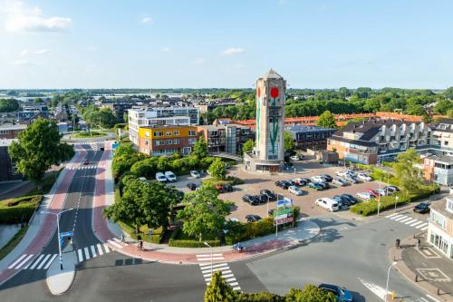 an aerial view of a city with a clock tower at B&B De Tulpentoren in Roelofarendsveen