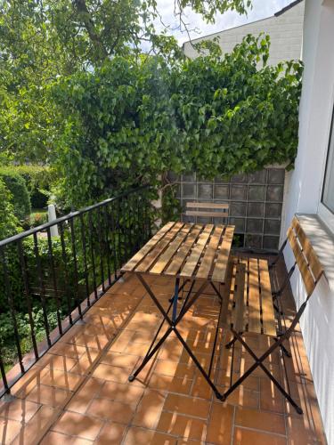 a wooden table and bench on a balcony at Charming Stadtvilla from 1895 Classic en Elegant in Kleve