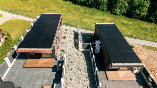 an overhead view of two buildings with roofs at Góralski Harem Osada Glamp & Glass z Jacuzzi i Balią in Zakopane