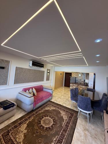 a living room with a couch and a table at Seaview 3-bedrooms chalet in maamoura beach resort , Alexandria in Alexandria