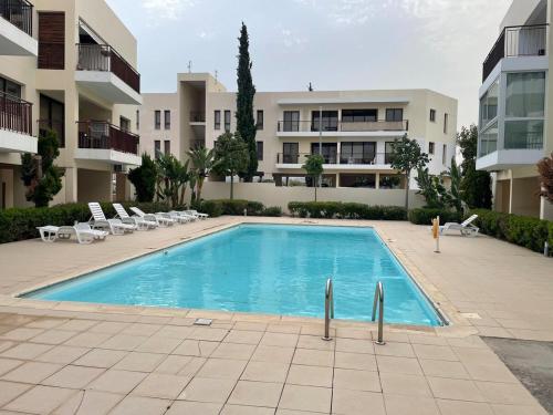 a swimming pool in front of a apartment building at Cozy sea view Apartment in Mazotos